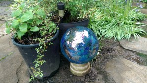 The new gazing ball, honoring the hold one; this one already broken, a mosaic of shattered glass.