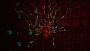 Grieving is a very human experience.  Detail of "Emotion and Reason" 18" x 24" acrylic on canvas w/ceramic and glow, photographed in dim light. 2012