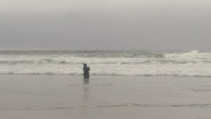 A fisherman, actually fishing.