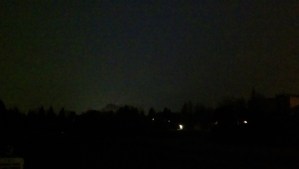 The darkness before dawn is dotted with bright  lights.